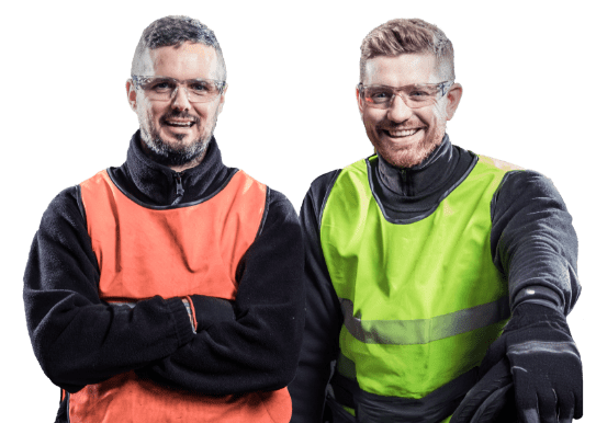 Two employees smiling, in high-vis clothing.