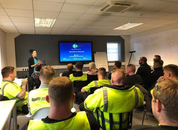 Smiley Monroe employees receiving a presentation on 'Nourish to Flourish'